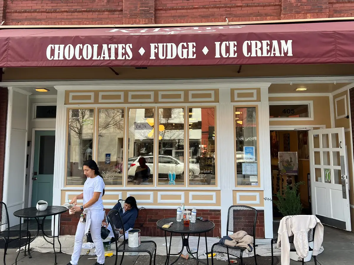 exterior of sweets shop painted in white and light beige