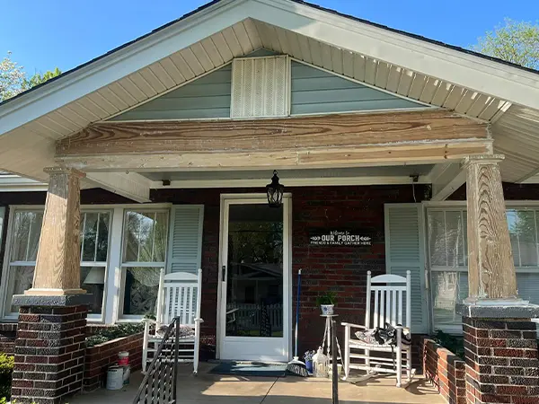 home with wood pillars before painting