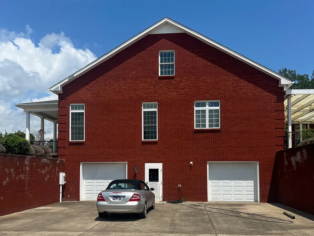 red brick exterior house with white doors and windows