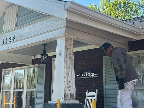 a porch with a white roof with worn out paint